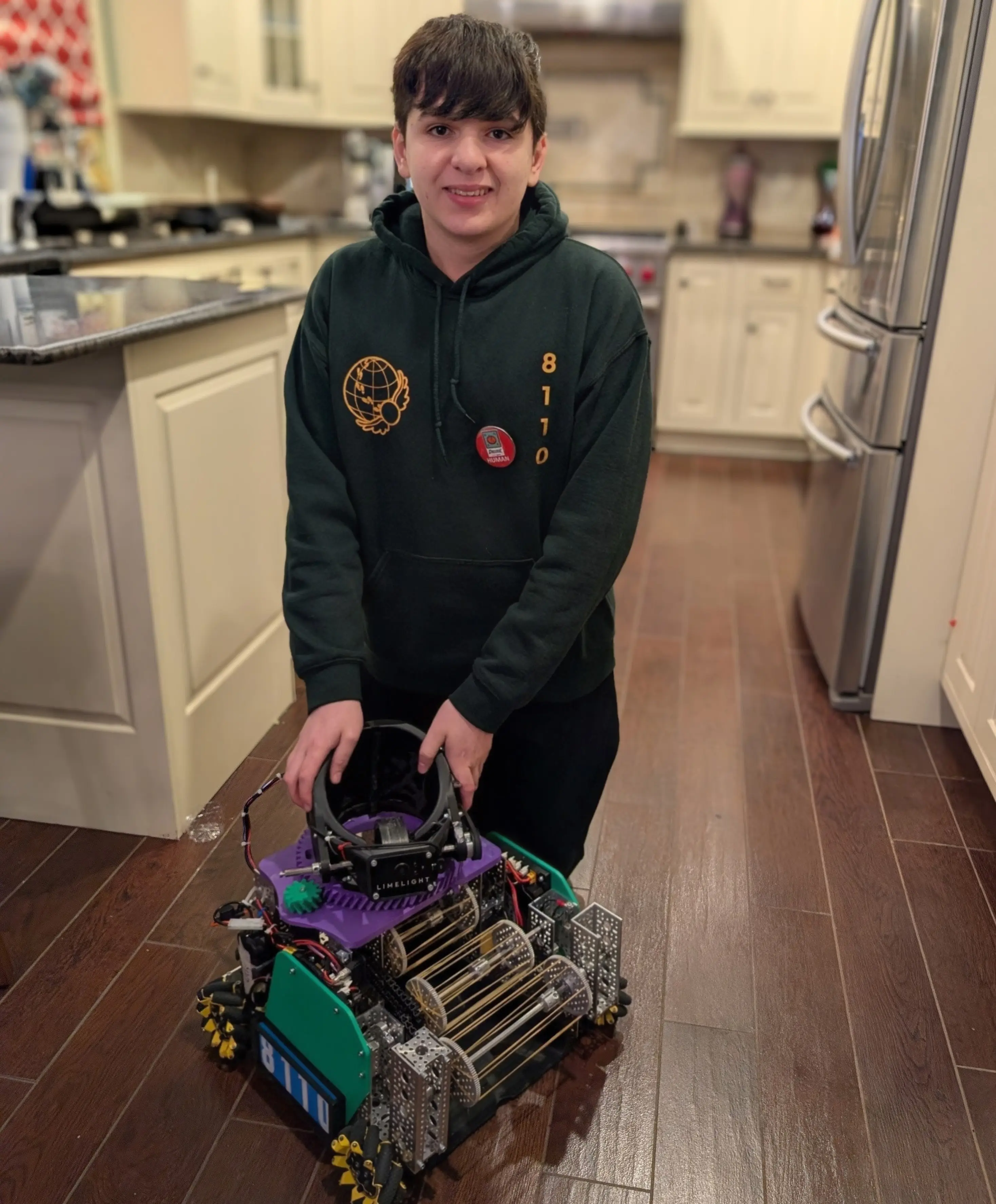 Galileo Solis building an FTC robot at his workbench
