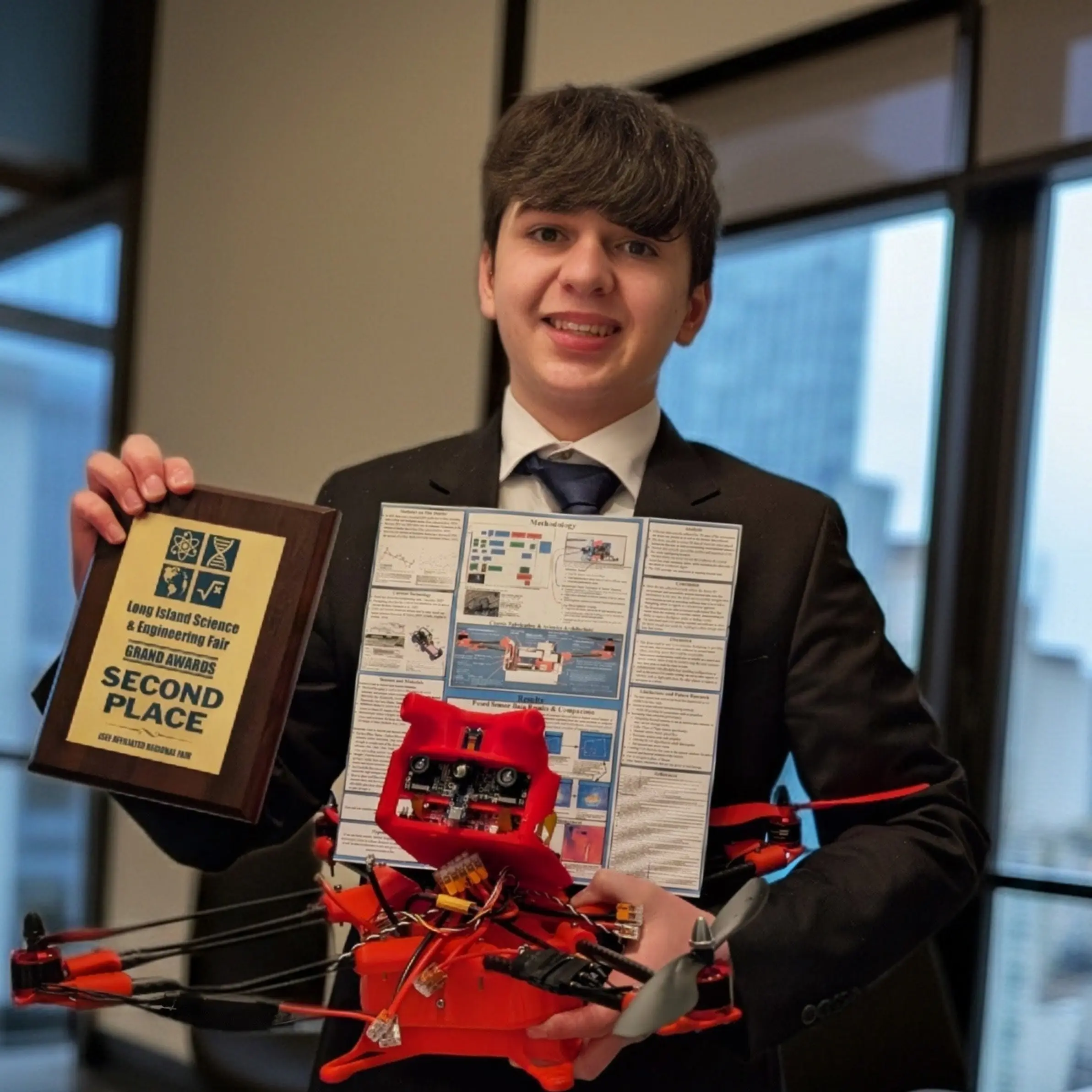 Galileo Solis holding Project Phoenix drone and LISEF 2nd Place Grand Award